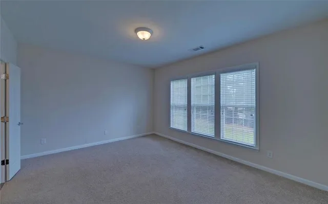 a view of an empty room and a window