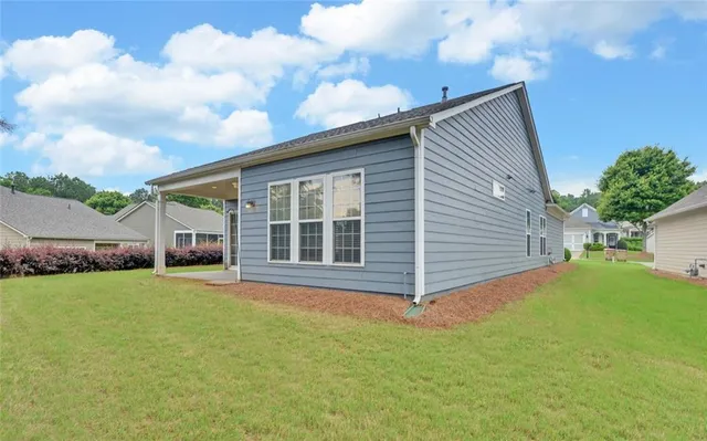 a view of an house with backyard space and garden