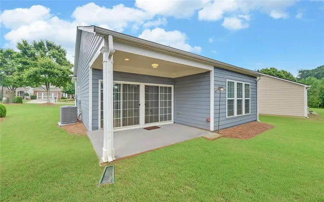 a view of a house with a yard porch and sitting area