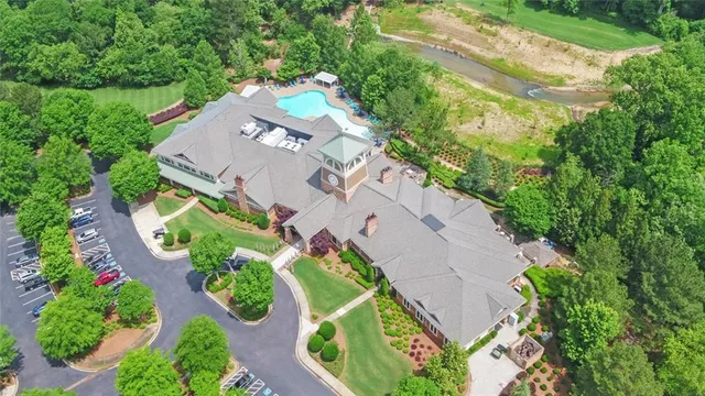 an aerial view of a house with a yard and lake view