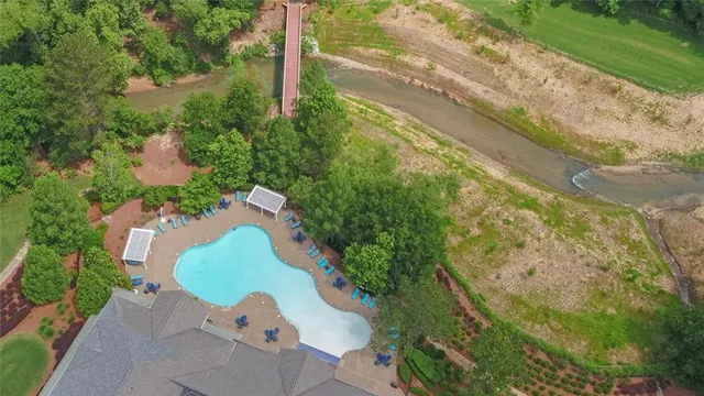 an aerial view of a house with swimming pool and outdoor space