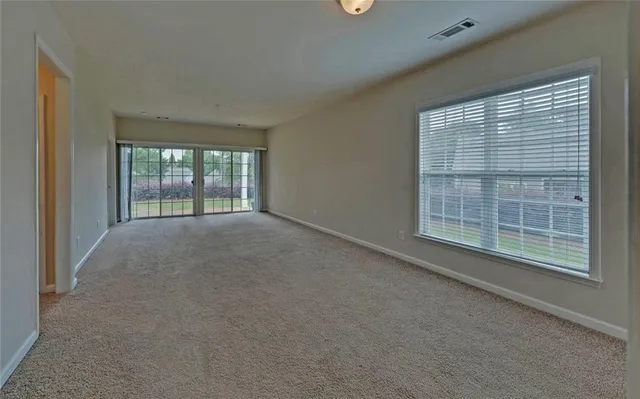 an empty room with windows and closet