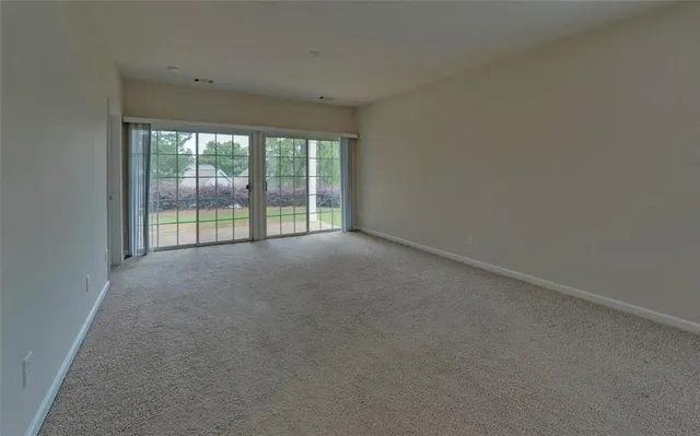 a view of empty room with floor to ceiling window