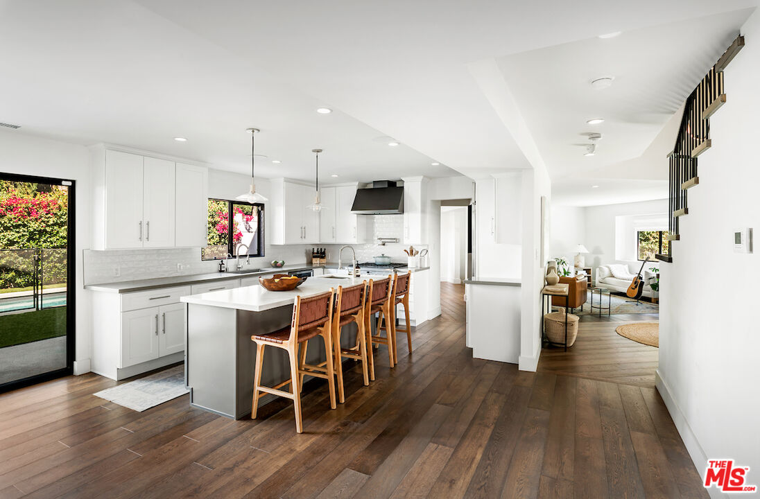 17003 Rancho Street Encino, CA 91316 - Photo 11 of 29 a kitchen with a table chairs refrigerator and cabinets
