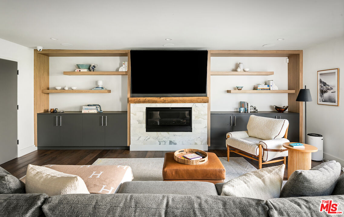 17003 Rancho Street Encino, CA 91316 - Photo 13 of 29 a living room with furniture and a flat screen tv