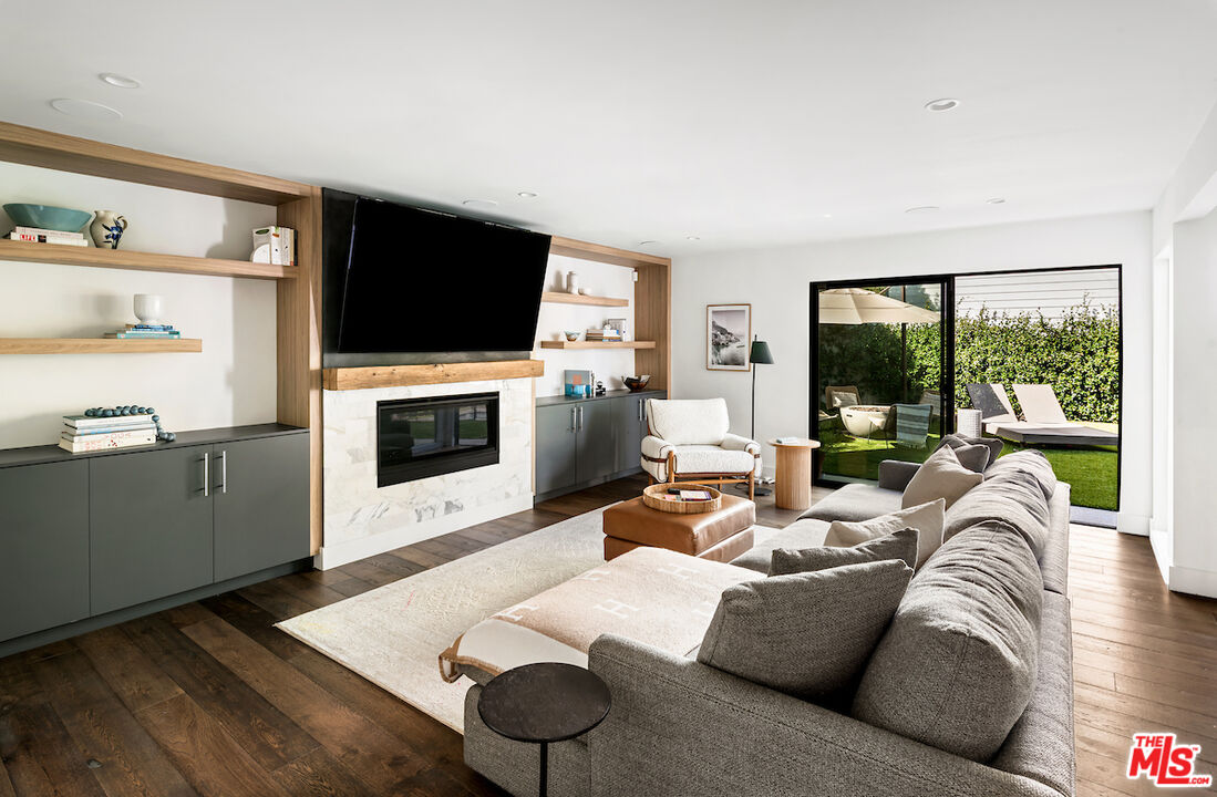 17003 Rancho Street Encino, CA 91316 - Photo 14 of 29 a living room with furniture a flat screen tv and a fireplace