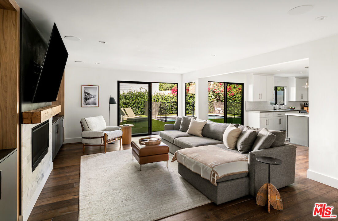 17003 Rancho Street Encino, CA 91316 - Photo 15 of 29 a living room with furniture fireplace and flat screen tv