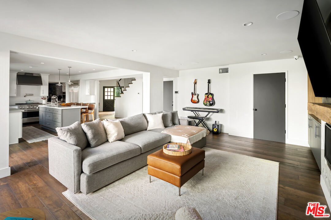 17003 Rancho Street Encino, CA 91316 - Photo 16 of 29 a living room with furniture and a flat screen tv