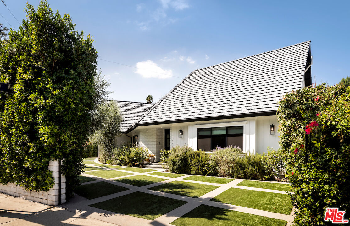 17003 Rancho Street Encino, CA 91316 - Photo 2 of 29 a front view of a house with garden