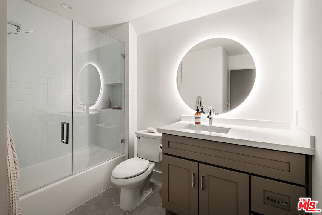 17003 Rancho Street Encino, CA 91316 - Photo 23 of 29 a bathroom with a sink a toilet and shower