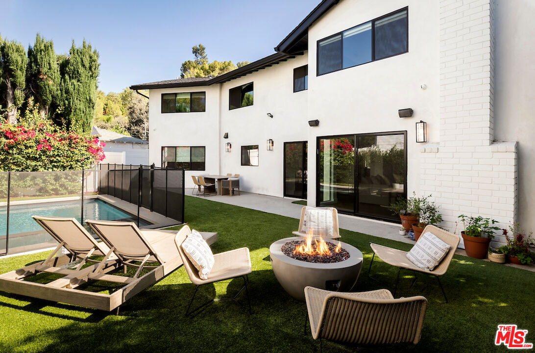 17003 Rancho Street Encino, CA 91316 - Photo 29 of 29 a view of a patio with couches table and chairs and potted plants