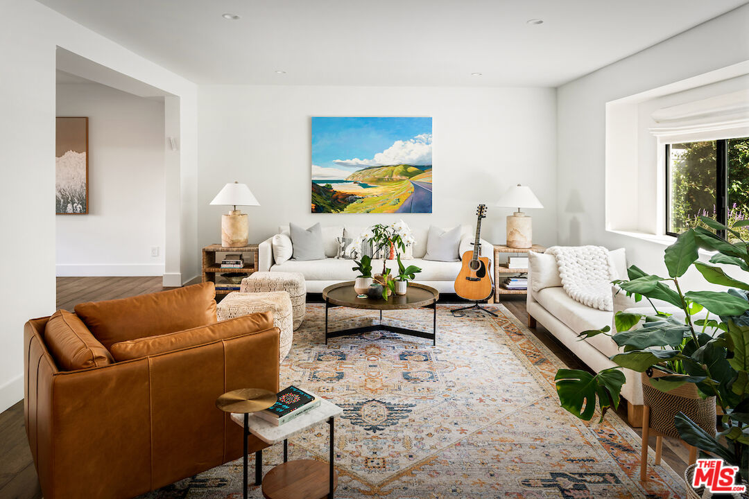 17003 Rancho Street Encino, CA 91316 - Photo 7 of 29 a living room with furniture a rug and a potted plant