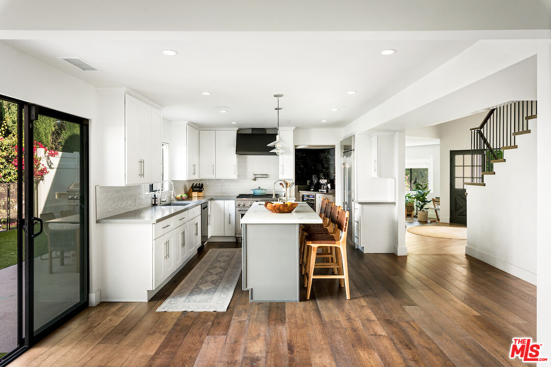 17003 Rancho Street Encino, CA 91316 - Photo 10 of 29 a kitchen with a sink appliances and wooden floor