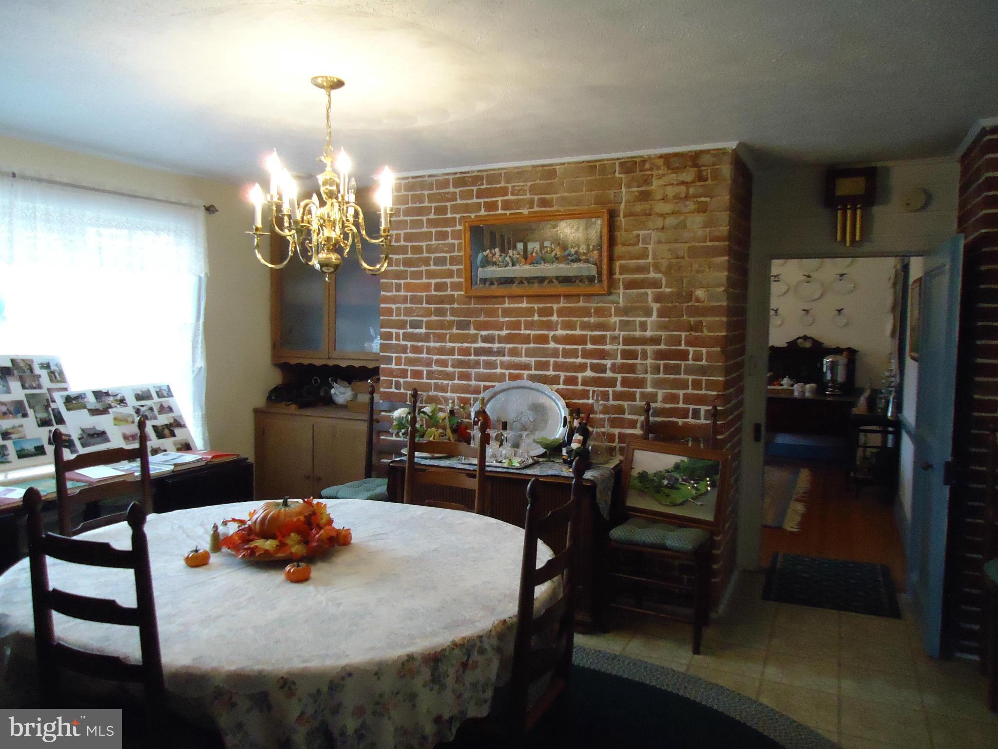 15671 Pratt Road Ridge, MD 20680 - Photo 14 of 30 a view of a dining room with furniture and chandelier