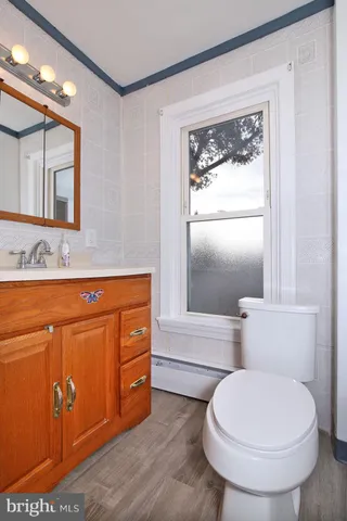 a bathroom with a toilet a sink and mirror