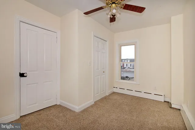 an empty room with a empty space and a ceiling fan