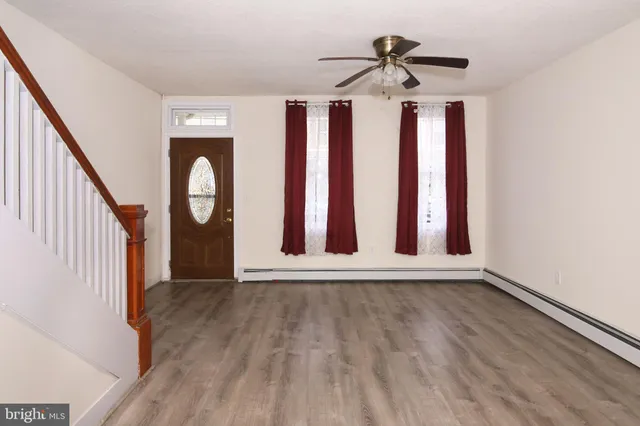 a view of an entryway with wooden floor and door