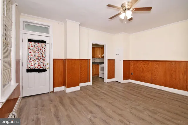 wooden floor in an empty room with a window