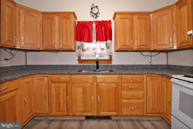 a kitchen with stainless steel appliances granite countertop wooden cabinets a sink and dishwasher