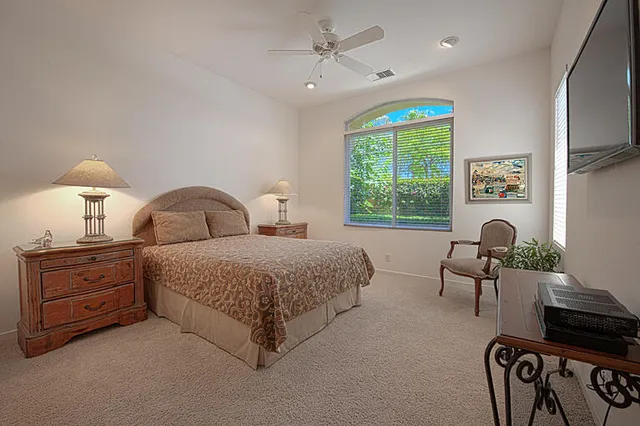 a view of backyard with a table and chairs and potted plants