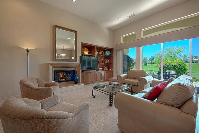 a kitchen with stainless steel appliances kitchen island granite countertop a refrigerator oven a sink a stove and white cabinets