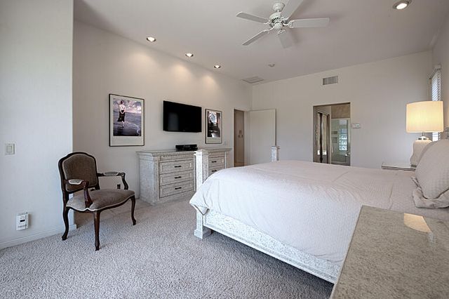 a bedroom with a bed and a chair