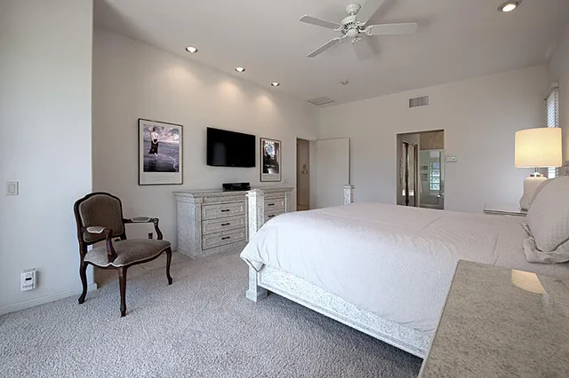 a bedroom with a bed and a chair