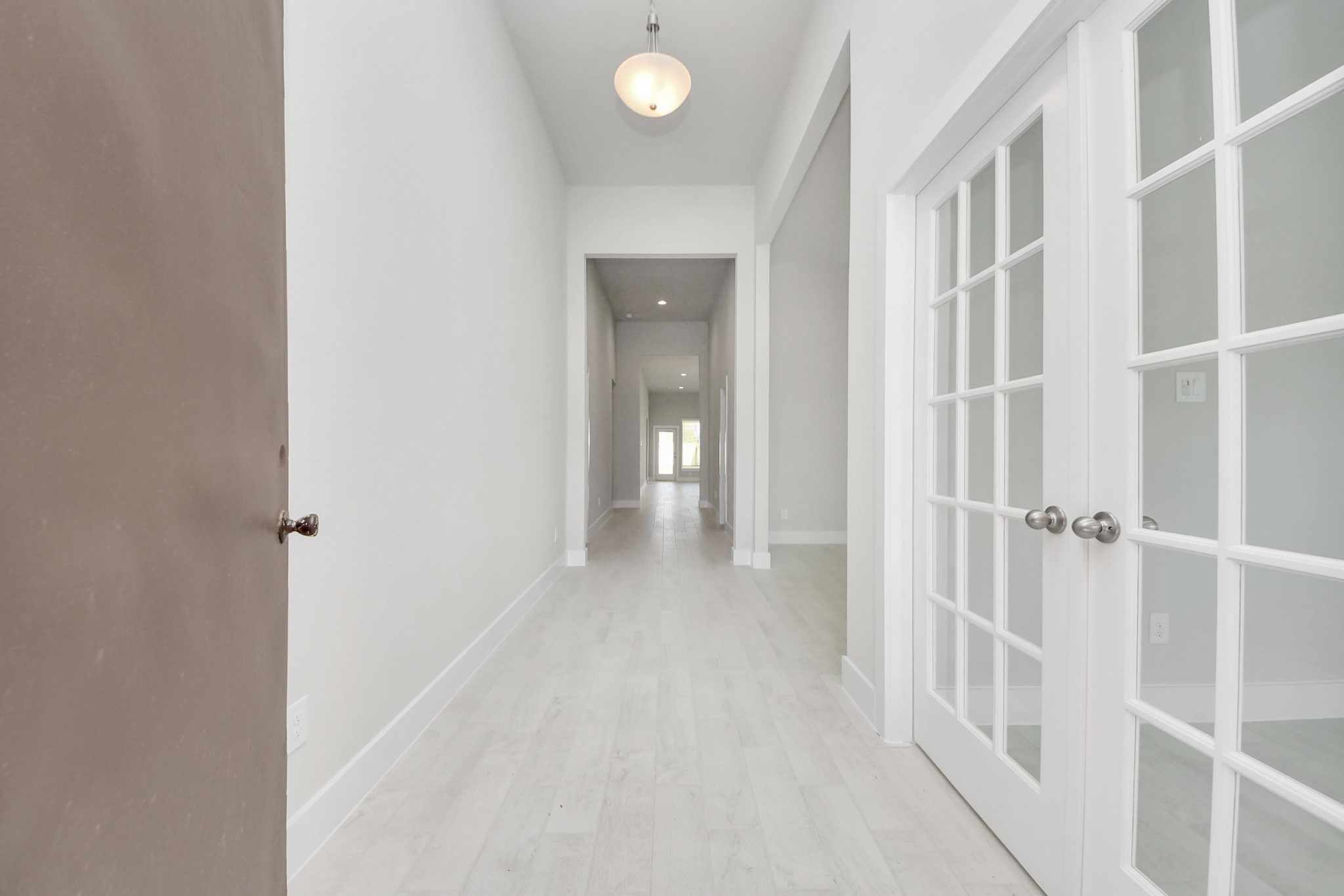 3042 Native Spg Drive Spring, TX 77373 - Photo 3 of 32 As you step into the threshold of this luxurious home, you'll soon be welcomed by an elegant glass door (to be installed). Inside, soaring ceilings amplify the spaciousness, while the refined wood-look tile flooring and oversized baseboards exude sophistication and charm. Sample photo of completed home with similar floor plan. Actual colors and selections may vary.