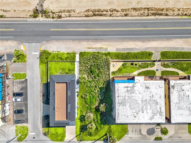 a view of swimming pool with lawn chairs and potted plants