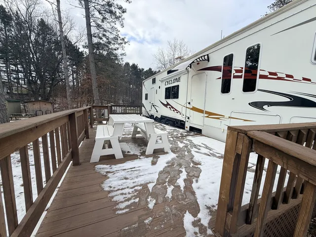 a view of a balcony with furniture and wooden floor
