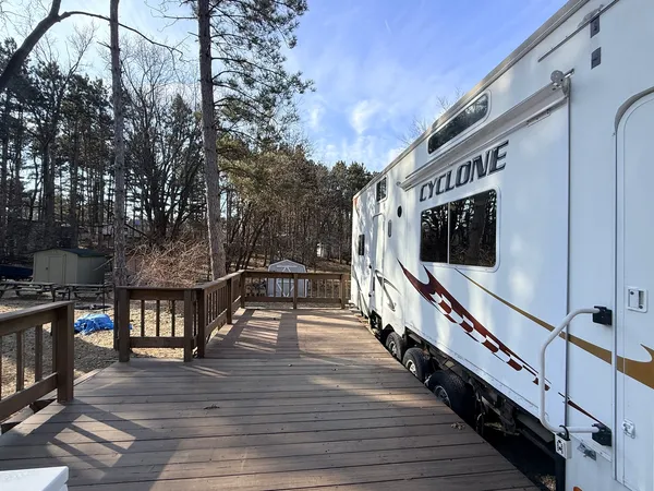 a view of a balcony with wooden floor and fence