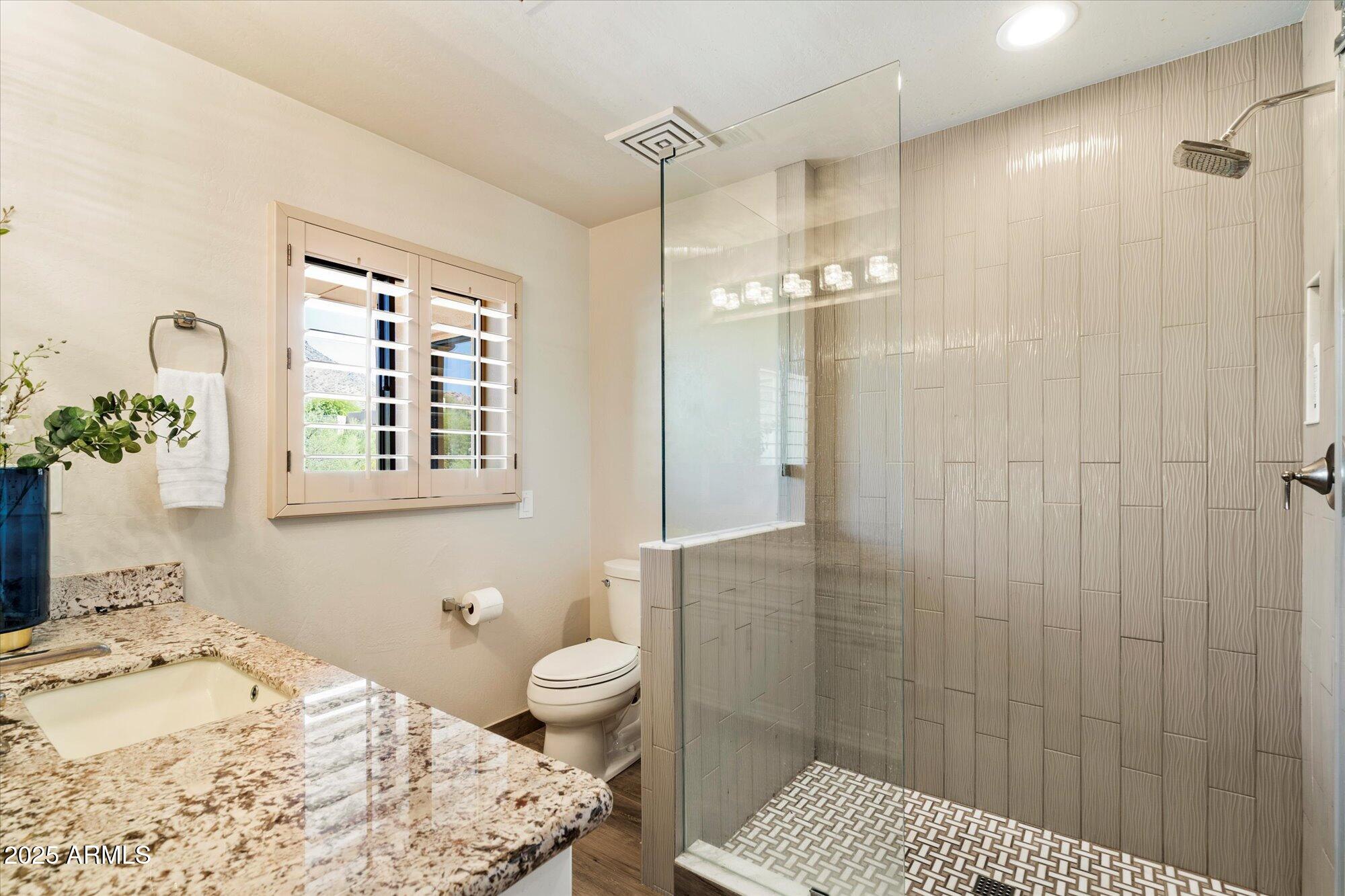 10801 East Happy Valley Road, Unit 133 Scottsdale, AZ 85255 - Photo 35 of 75 a bathroom with a sink a toilet and shower
