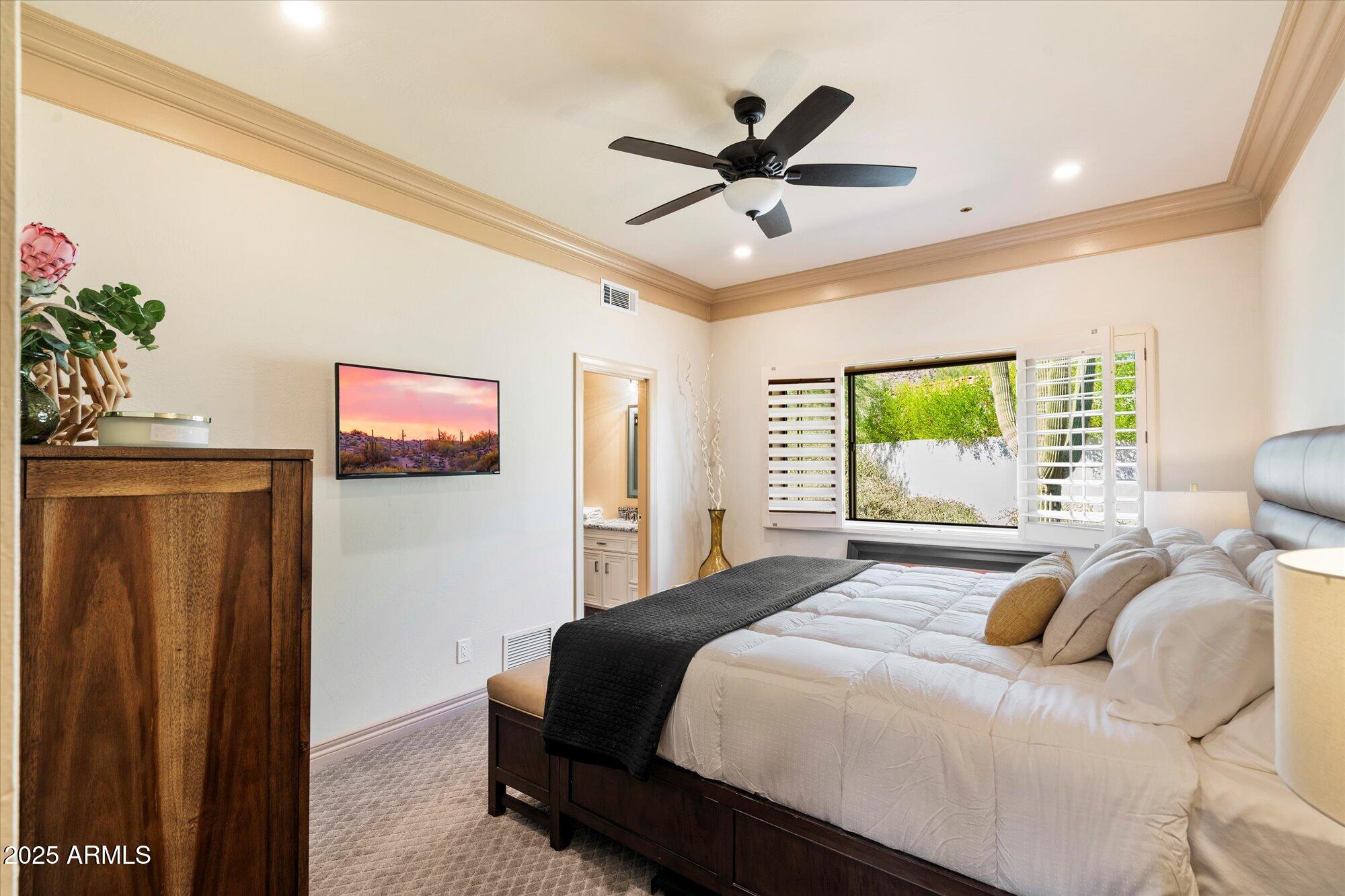 10801 East Happy Valley Road, Unit 133 Scottsdale, AZ 85255 - Photo 36 of 75 a bedroom with a large bed and a chandelier