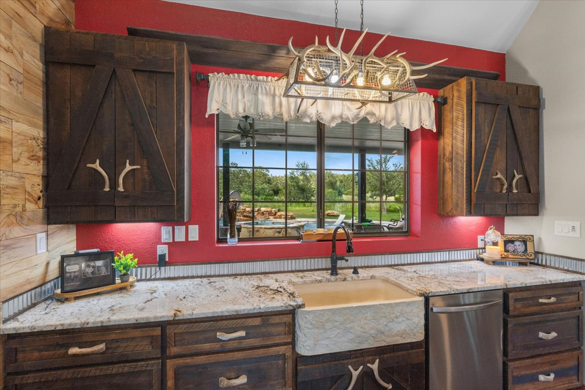 175 Wilson Road Elgin, TX 78621 - Photo 11 of 40 This might just end up being your favorite spot to do dishes! Look at that stone apron-front sink! While you’re standing here, you get a direct view right out over the patio and pool area, so you can easily keep an eye on everyone outside.