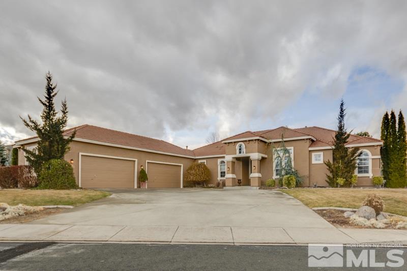 5265 North Elk River Road Reno, NV 89511 - Photo 1 of 25 a front view of a house with a yard and garage
