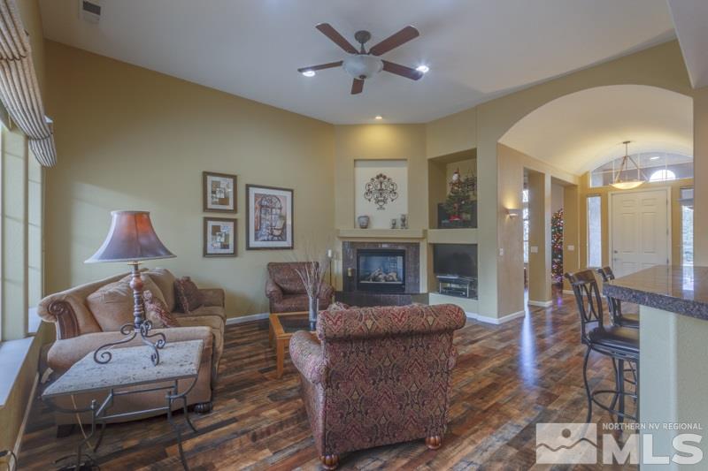 5265 North Elk River Road Reno, NV 89511 - Photo 11 of 25 a living room with furniture a fireplace and a chandelier