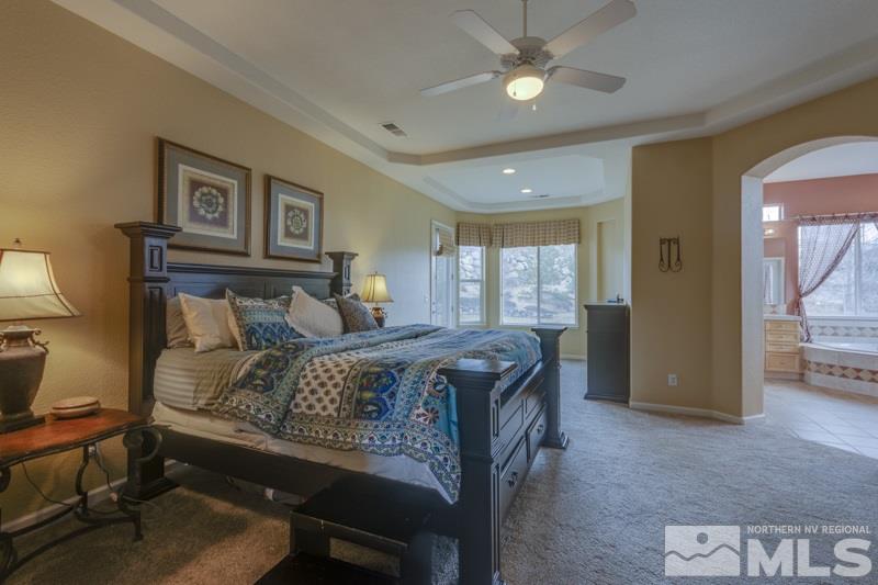 5265 North Elk River Road Reno, NV 89511 - Photo 13 of 25 a bedroom with a bed and a chandelier