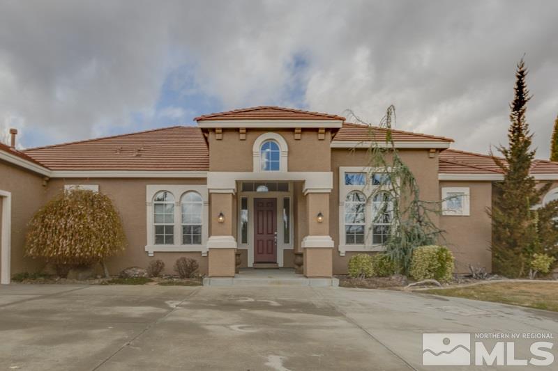 5265 North Elk River Road Reno, NV 89511 - Photo 2 of 25 a front view of a house with a garden