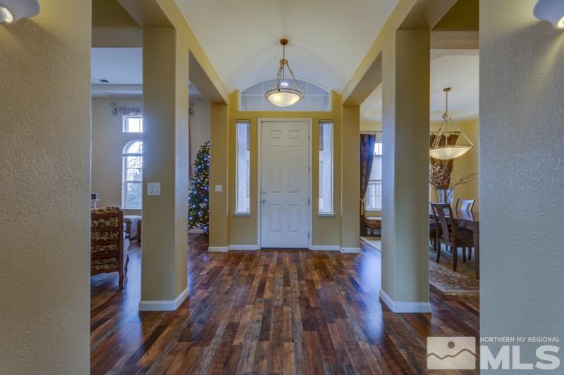5265 North Elk River Road Reno, NV 89511 - Photo 3 of 25 a view of a hallway with wooden floor and staircase
