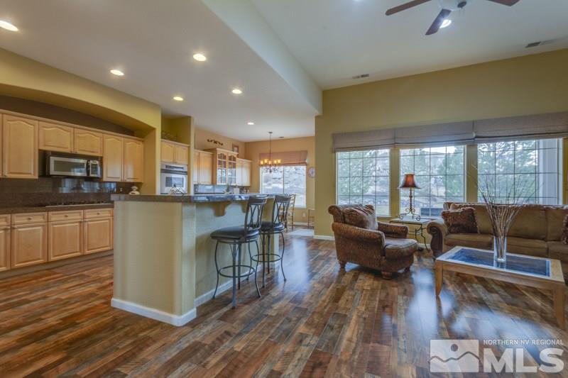 5265 North Elk River Road Reno, NV 89511 - Photo 10 of 25 a living room with stainless steel appliances furniture wooden floor and a kitchen view