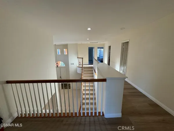 a view of staircase with railing and a rug