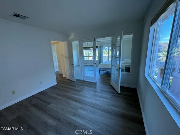 a spacious bathroom with a double vanity sink a large mirror and shower