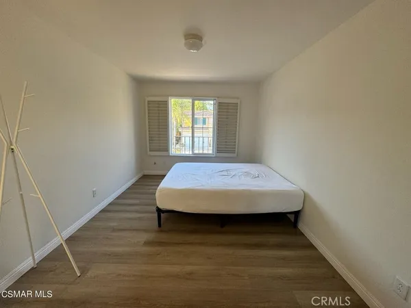 a bed sitting in a bedroom next to a window
