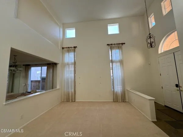 a view of a dining room with a table and chairs