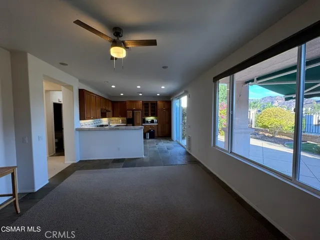 a view of a livingroom with furniture and a kitchen