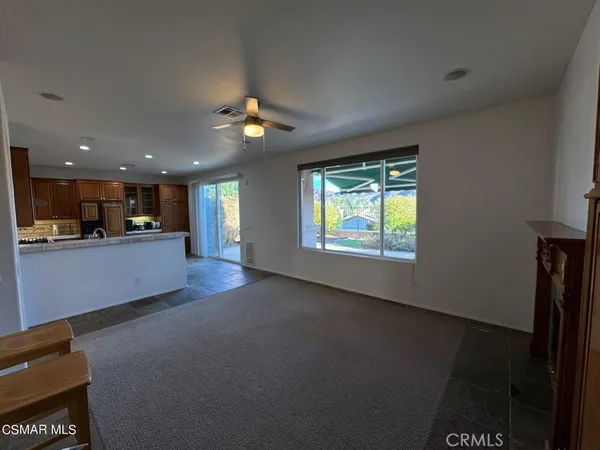 a kitchen with stainless steel appliances granite countertop a refrigerator and a stove top oven with wooden floor