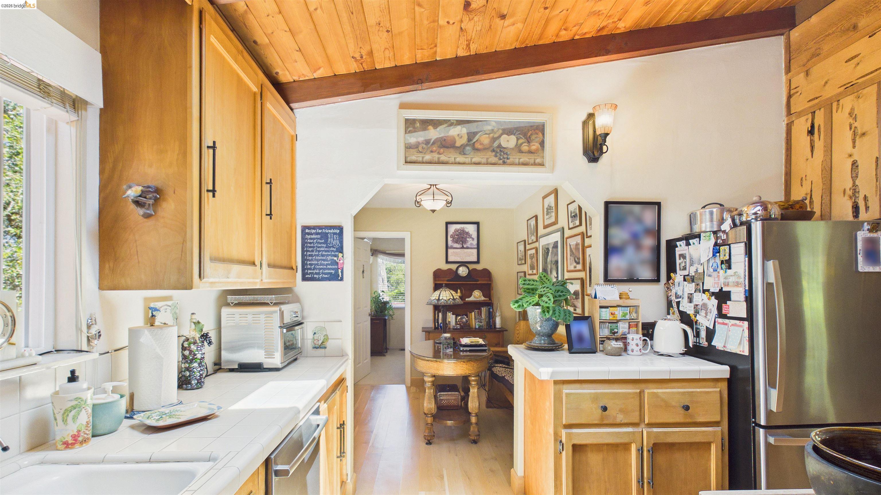 18102 Mt Eaton Road Tuolumne, CA 95379 - Photo 11 of 44 Kitchen featuring natural wood cabinetry and a sloped wood-paneled ceiling with an exposed beam