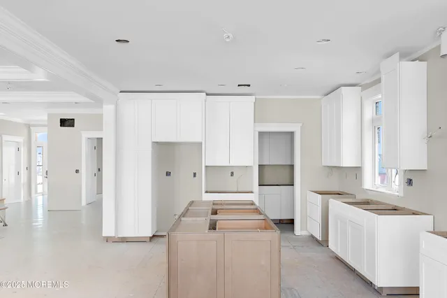 a living room with furniture and large windows