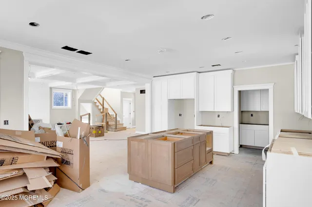 a big room with furniture and a chandelier