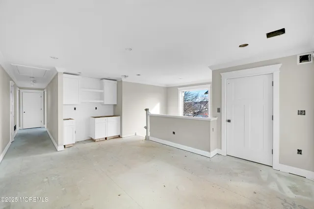 an empty room with windows and painted walls